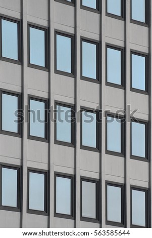 Windows of an office building reflecting blue sky. Tilt photo of modern architectural fragment. Abstract image of contemporary architecture.