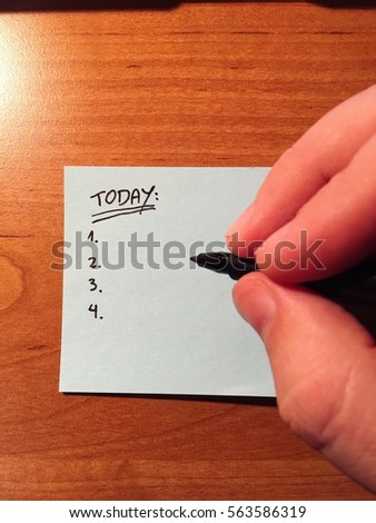 Person writing a today's to do list