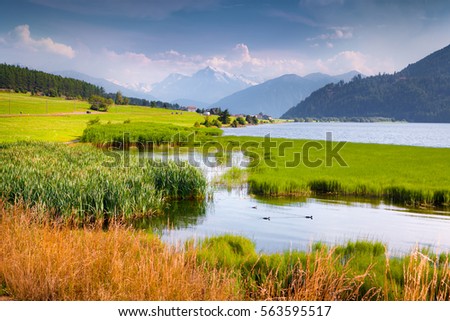 Colorful summer view of Ortler summit. Morning mist on the  Muta lake (Haidersee), St. Valentin village location, South Tyrol, Italy, Europe. Artistic style post processed photo.
