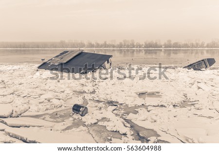 Water objects trapped on frozen river Danube and many ice cubes, Belgrade Serbia, sephia effect