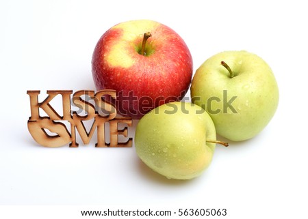 red and green color apple fruit with vitamin for healthy diet with wooden "kiss me" text isolated on white background