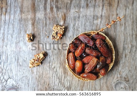 Dried Medjool Dates, The best natural sugar/ sweetener in the  woven basket on the wooden table.   Royalty-Free Stock Photo #563616895