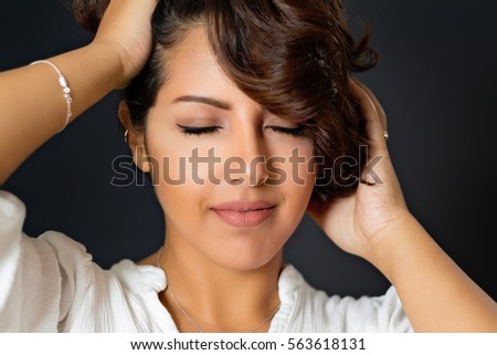 Beautiful young woman with eyes closed