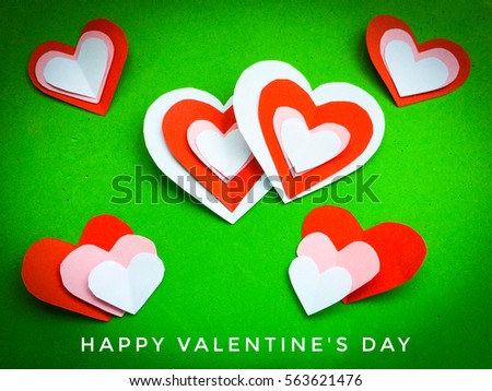 Overlapping cutting paper red heart isolated on green  background. You can use as greeting card with text or with out text "Happy Valentine's Day"