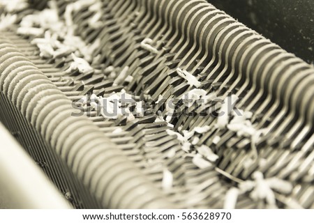 cross-cut paper shredder work/Gears and cogs macro Royalty-Free Stock Photo #563628970