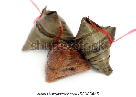 Close up of three rice dumplings over white background.