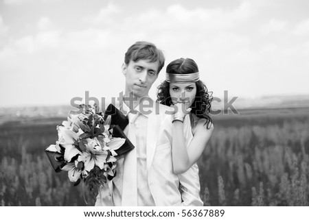 just married couple on the field. black-and-white photo