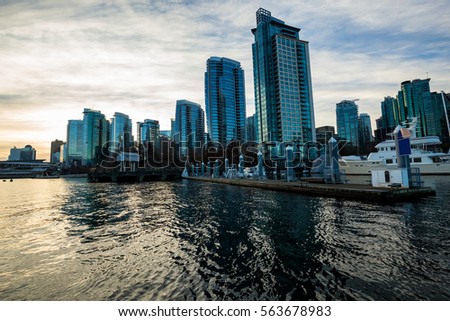 City view of Downtown Vancouver from Coal Harbour. Picture taken during a cloudy winter sunrise.