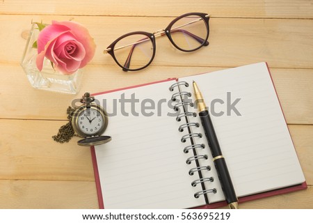 accessory of business and pink rose on wooden background