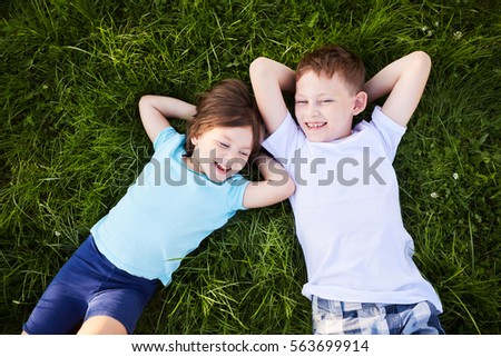 summer photo of happy children. Picture of brother and sister having fun in the park