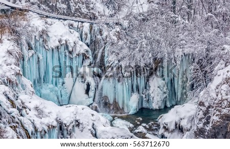 Winter panorama of frozen waterfalls at Plitvice lakes in Croatia.