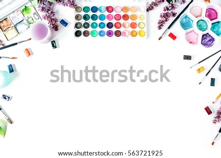 Artist workspace. Watercolor and brushes on white background. Flat lay, top view Royalty-Free Stock Photo #563721925