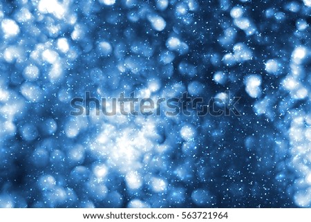 Abstract round  bokeh or glitter lights on blue background. Circles and defocused particles.