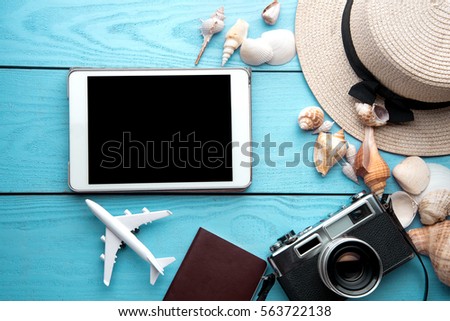 Summer holiday background, travel concept with tablet and camera on wooden table background