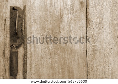 Old and rusty vintage two sharp knife on wood background in sepia picture style