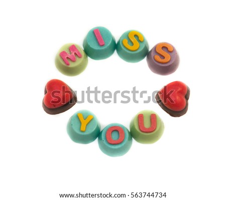 Letters chocolate miss you in Valentine's Day on white background.