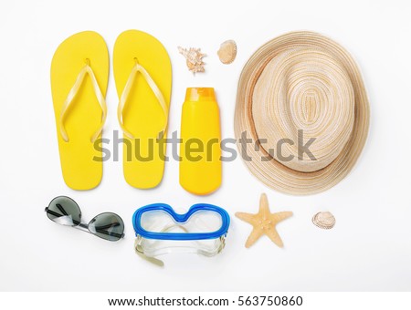 Variety beach accessories on white background. Vacation and travel items, top view