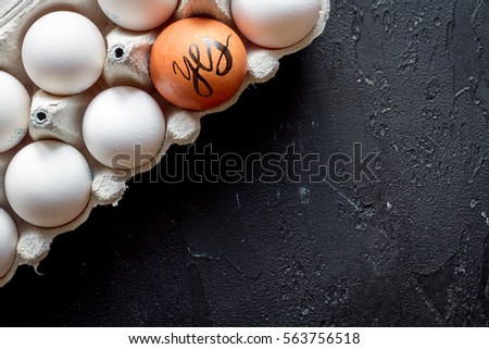 concept of correct choice eggs on dark background top view