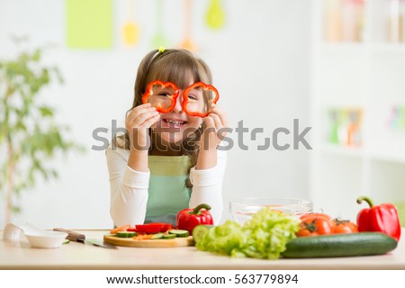 kid girl having fun with food vegetables at nursery room Royalty-Free Stock Photo #563779894