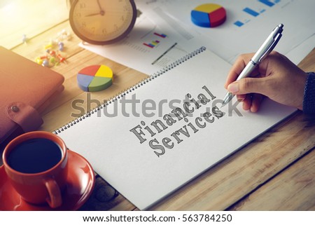Man hand writing word financial services
