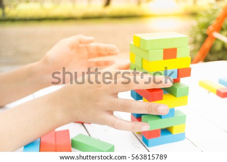 Colorful wooden blocks with woman hands for Learning and development background concept
