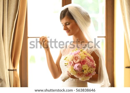 bride posing with her wedding bouquet