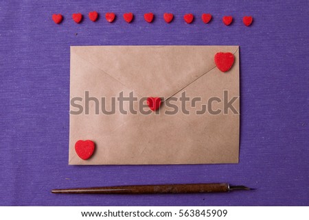 Vintage envelope with letter, pen and red heart shapes. Writing love letter. Happy Valentine's day concept.