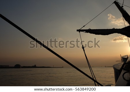 silhouette picture of mast ship and sunset view from the ship