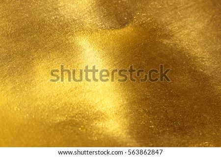 Shiny yellow leaf gold foil texture background Royalty-Free Stock Photo #563862847