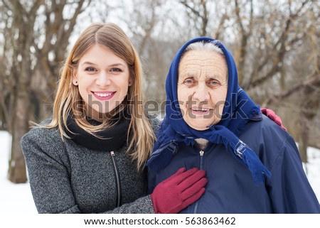 Picture of a cute elderly woman with her helping caretaker