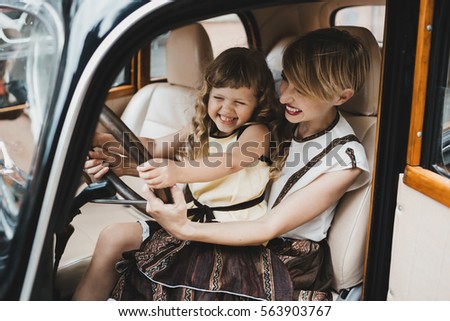 The mother with daughter sitting in the car Royalty-Free Stock Photo #563903767