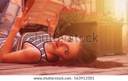 Beautiful young woman reading a book. (relax, romance, poetry, rest)
