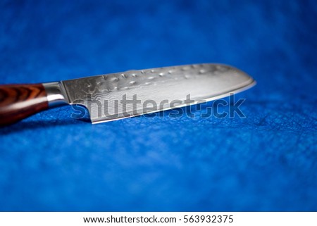 Sharp nice Japanese knife on blue background.NEF