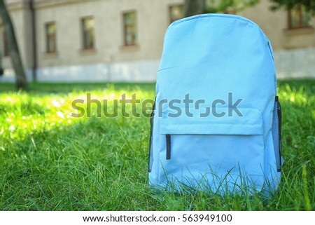 Blue rucksack on green grass