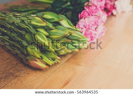 Flower shop background. Fresh buds and roses for bouquet delivery. Floral design studio, making decorations and arrangements.