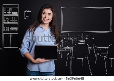 Cheerful professional teacher standing in the classroom