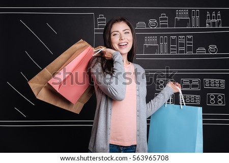 Overjoyed woman enjoying shopping Royalty-Free Stock Photo #563965708