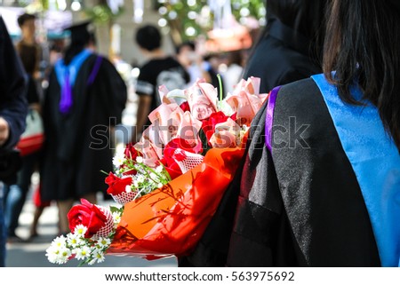 graduate holding a bouquet of money  bank flower