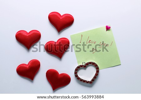 Note, "I love you!" and red hearts around it, on white background.