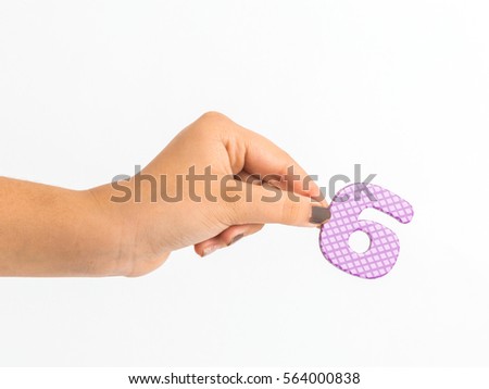 Hand holding number six isolated on a white background