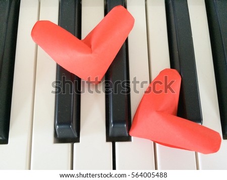 Overlapping paper red hearts on Piano Keyboard background. You can use as greeting card with text or with out text "Happy Valentine's Day"