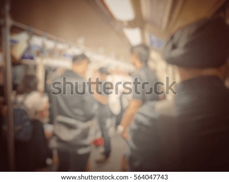 Blurred image of city people lifestyle standing inside the train on the way go to work every morning.