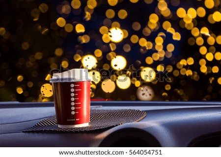 Plastic cup was placed in the car, blur image of windshield as background.