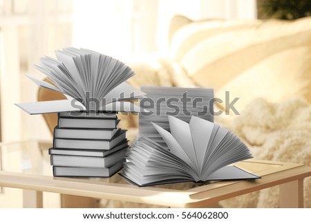 Stack of new books on table in living room