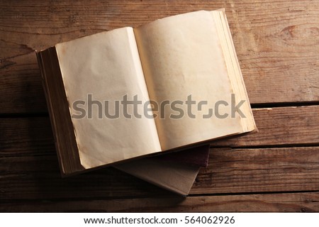 Old books on wooden background, top view Royalty-Free Stock Photo #564062926