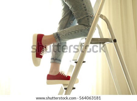 Photo of young girl climbing on ladder step by step Royalty-Free Stock Photo #564063181