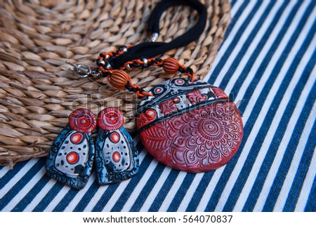 Unique jewelry pendant and earrings of polymer clay. Fashion background. Handmade jewelery. Bohemian accessories.