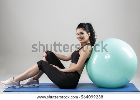beautiful woman with a ball isolated on background