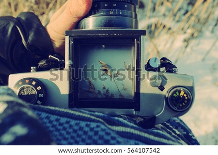 man photographer is making landscape photography with old film camera. top view.
