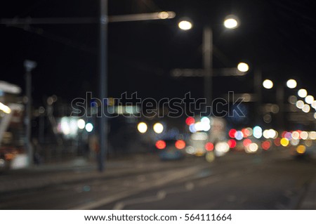 Evening traffic. The city lights. Motion blur and bokeh effect viewed from the road